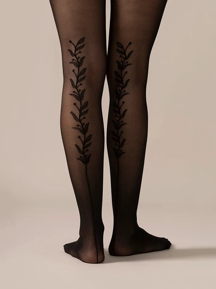 Back view close-up of the legs in the Back Vine Sheer Tights in Black, showing the vine pattern running up the back.
