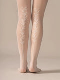 Back view of the legs in the Back Vine Sheer Tights in Creamy White, showing the vine pattern running up the back leg.