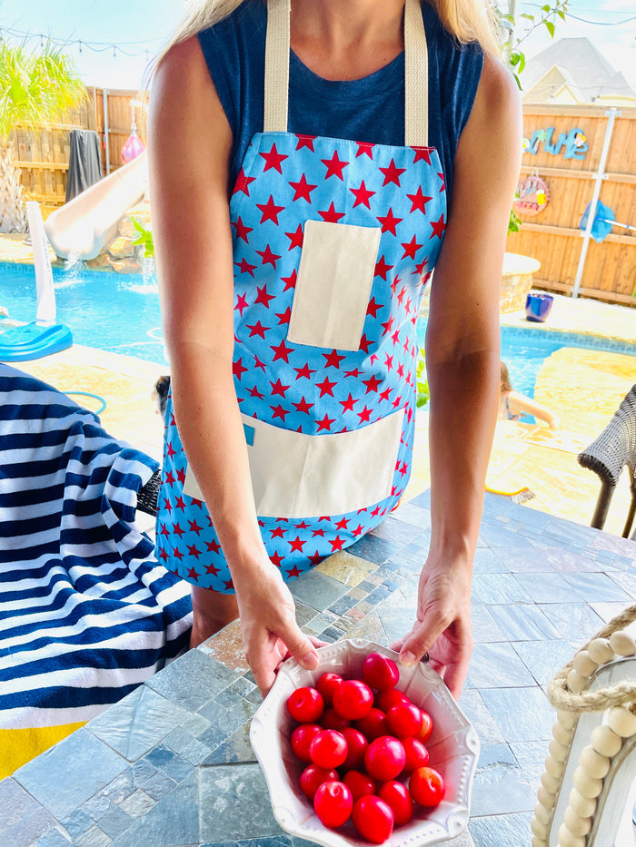 Amanda Bright Designs Betsy Ross kitchen apron fireworks stars blue American flag pattern fourth of july woman on her patio pool bbq grill backyard