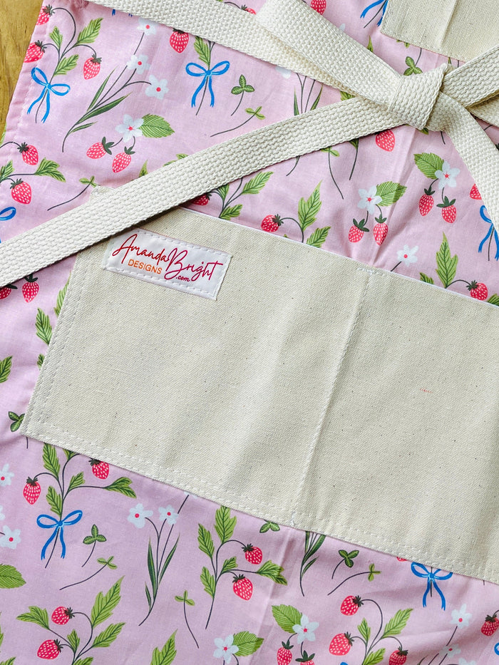 Amanda Bright Designs pink apron with strawberries blue bows white flowers