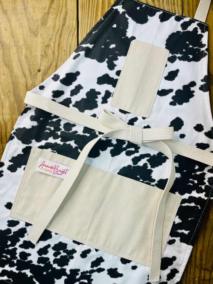 Amanda Bright Designs cheyenne horse lover western black and white cowhide print apron with webbed cotton strings and canvas pockets