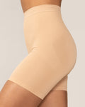 Beige shapewear shorts worn by a person on a neutral background