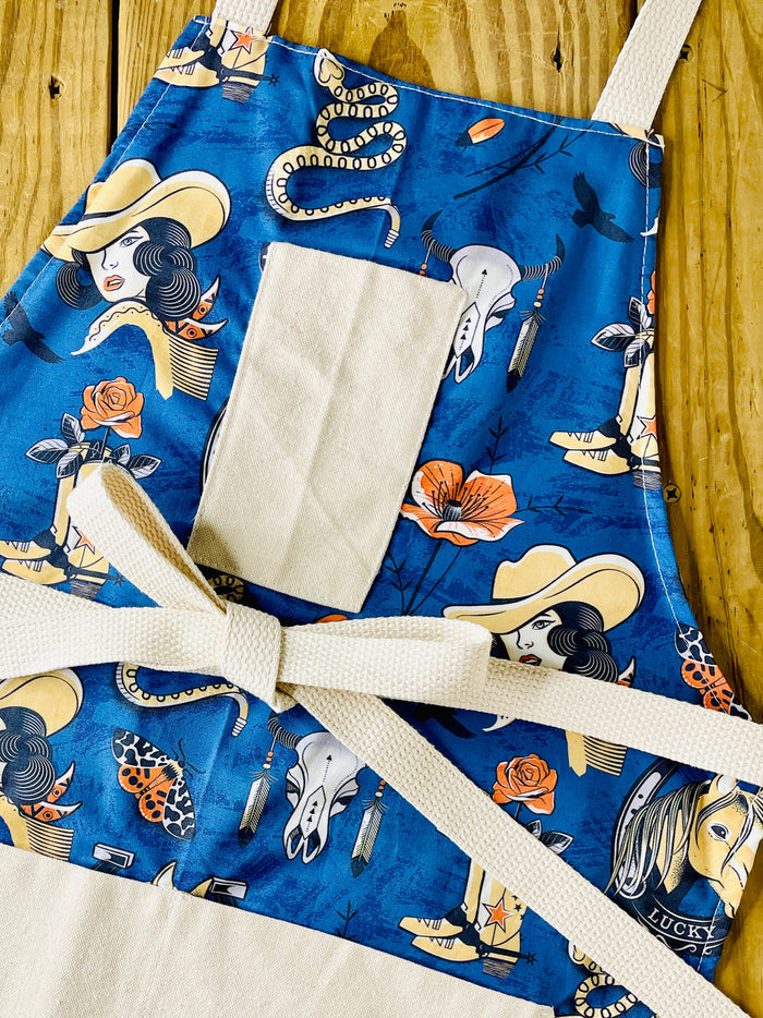 Amanda Bright Designs western apron, navy blue cowgirl, cowboy boots steer skull rattlesnake rose