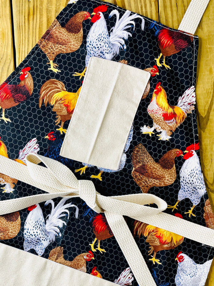 amanda bright designs chicken apron wih roosters an chicken wire black background