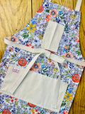 Amanda Bright Designs brightly colored floral patterned apron with pockets and strings