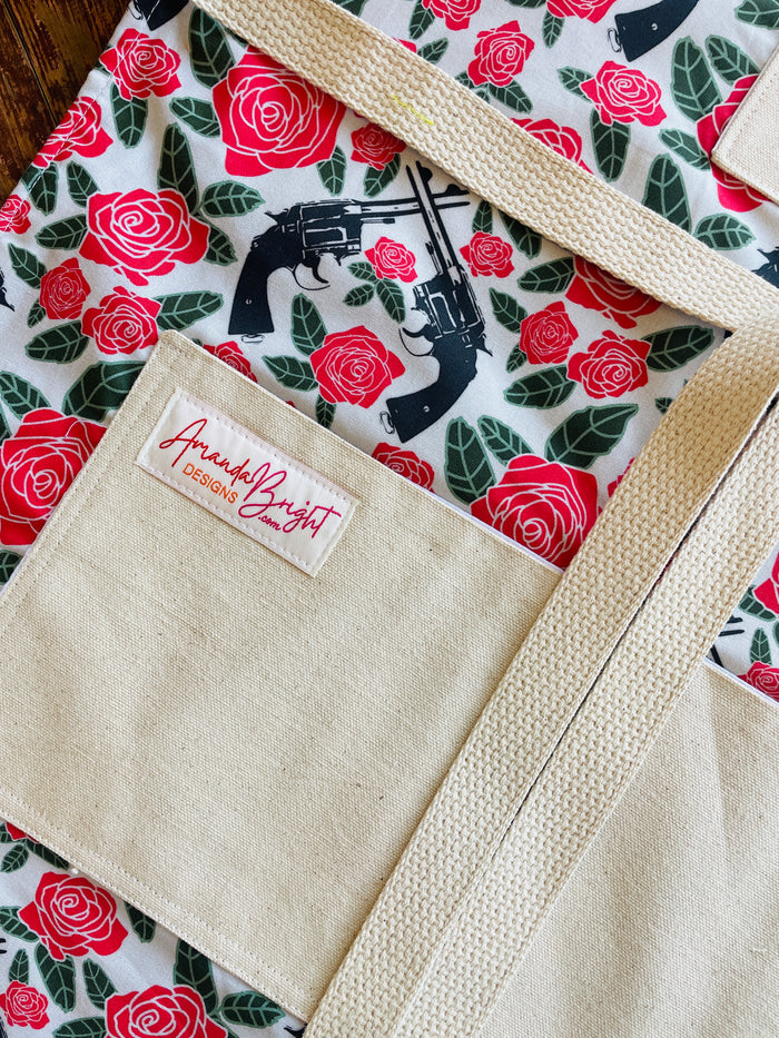 Amanda Bright Designs Floral apron with red roses and revolver guns