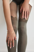 Close-up of Rachel's Lace Crown Over-the-Knee Tights in Olive, showing the lace pattern at the top of the thigh.