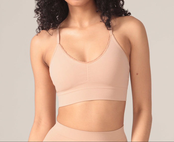 Woman wearing a beige bralette