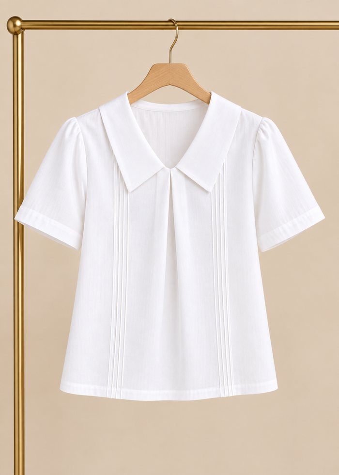 Flurr Maison Collar Top in white displayed on hanger showing statement collar and structured design