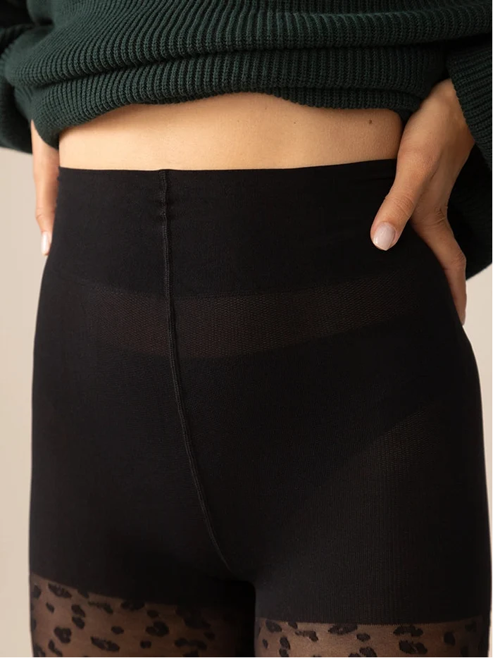 Close-up of the high-waisted Natural Smoothing Panty on Rachel's Mini Leopard Tights in Black.