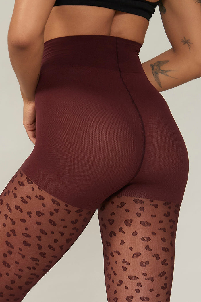 Detailed side view of the leopard print pattern with natural smoothing panty on Rachel's Mini Leopard Tights in Zinfandel.