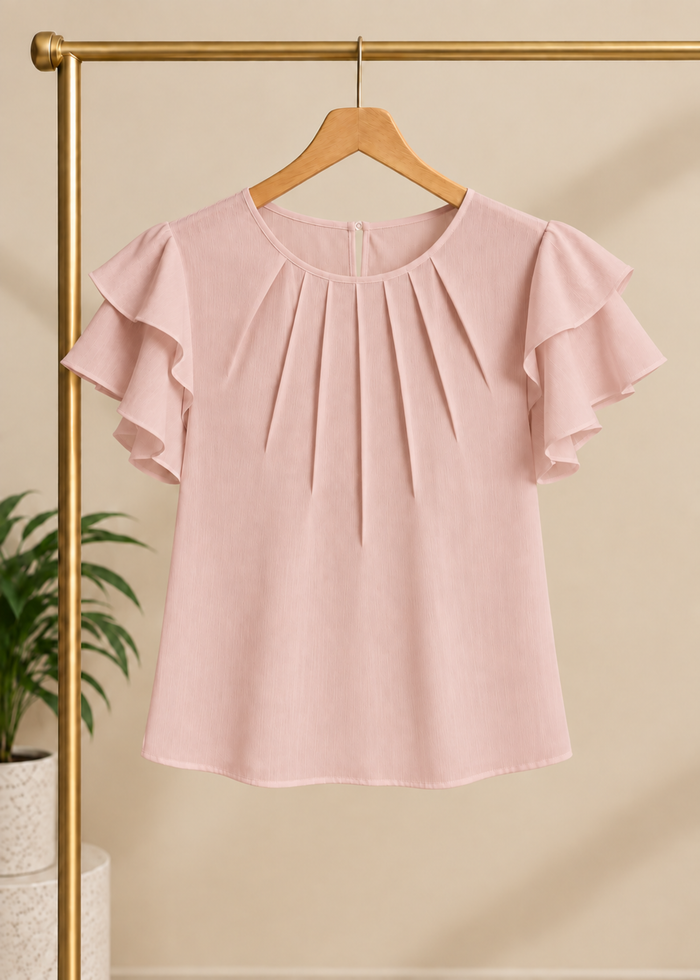 Flurr soft pink Pearl Pleat Top with flutter sleeves displayed on hanger