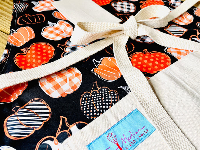 Amanda Bright Designs pumpkin spice everything black and orange closeup view of halloween farmhouse style apron