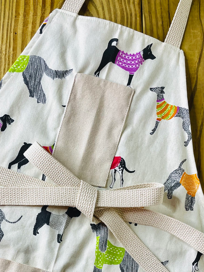 Amanda Bright Designs Pixie sweater wearing dog apron