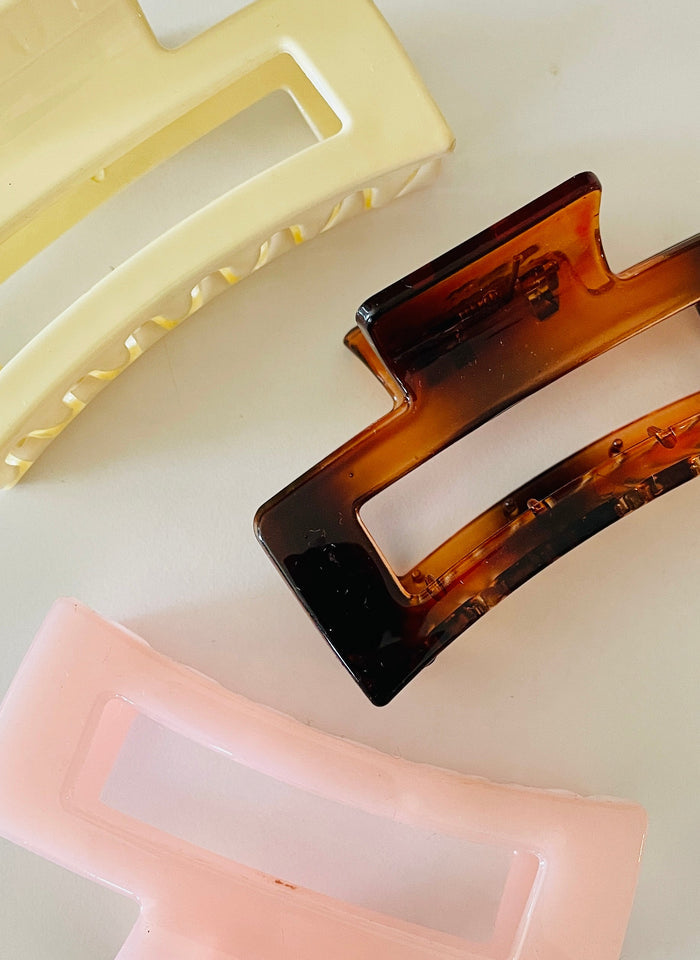 Amanda Bright Designs Three rectangular hair claws in beige, tortoiseshell, and pink on a white background