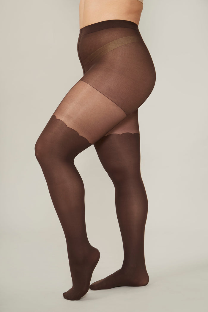 Brown sheer tights worn by a person on a plain background