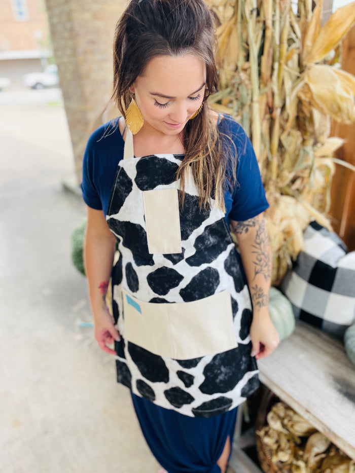 Susanna Apron cowhide black and white holstein Susanna Dickinson Lady of the Alamo model wearing cowprint apron