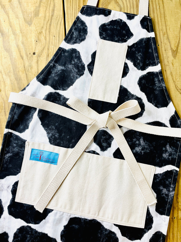 Susanna Apron cowhide black and white holstein Susanna Dickinson Lady of the Alamo modern farmhouse style kitchen cowprint pattern