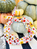 Amanda Bright Designs cotton fall headband featuring a colorful floral and leaf pattern squirrels and mushrooms on a white background