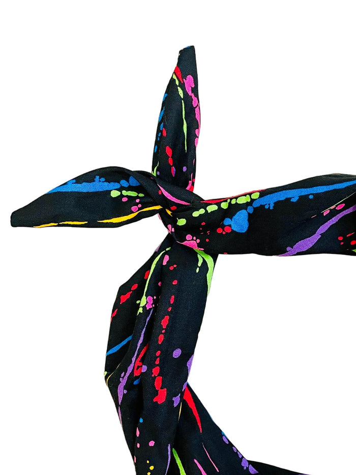 Amanda Bright Designs black headband with neon paint splatter close-up view