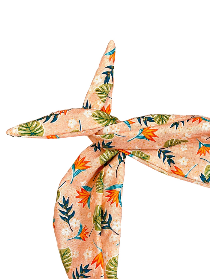Amanda Bright Designs peach-colored scarf with a tropical leaf and bird-of-paradise print