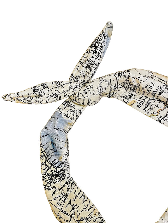 Map patterned headband tied in a knot on a white background
